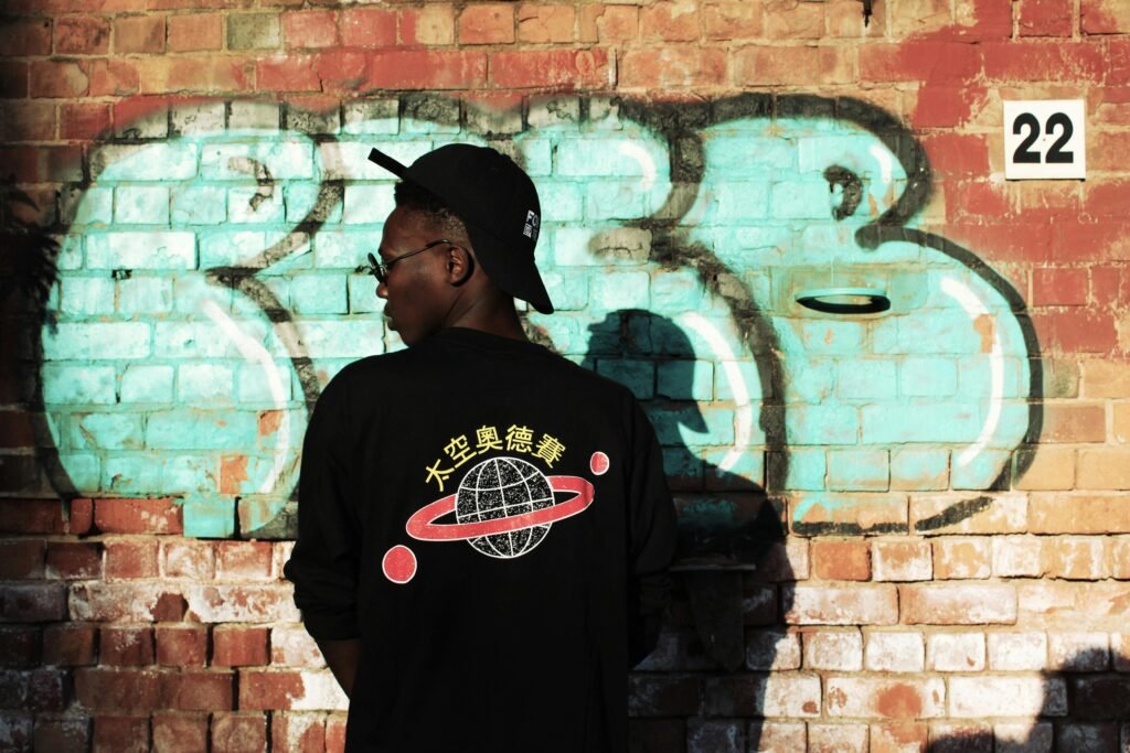 Trendy streetwear look with urban graffiti background, capturing vibrant city essence.